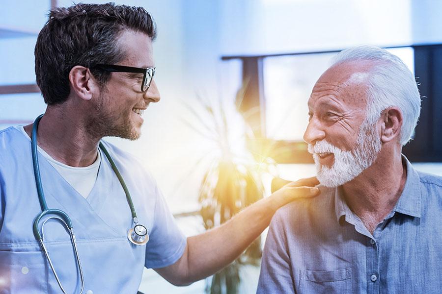 Friendly clinician engaging with a male patient