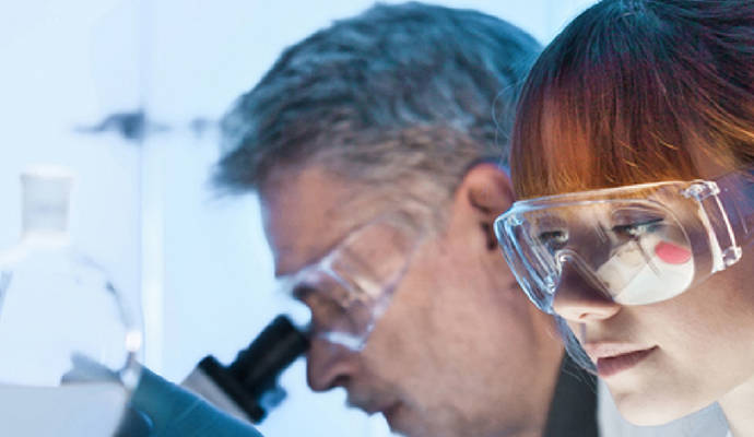 Close-up of faces of laboratory researchers wearing PPE