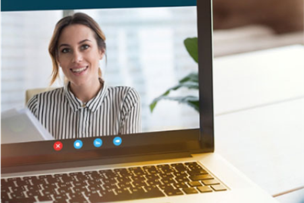 Female clinician smiling on zoom call